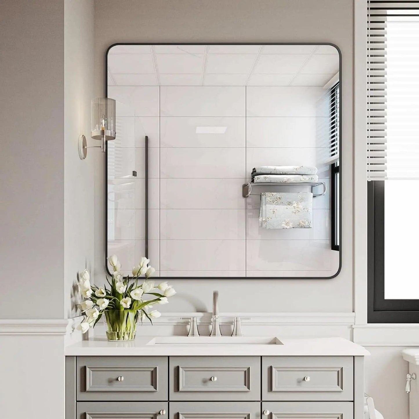 Bathroom vanity with large mirror, sink, and decorative elements.