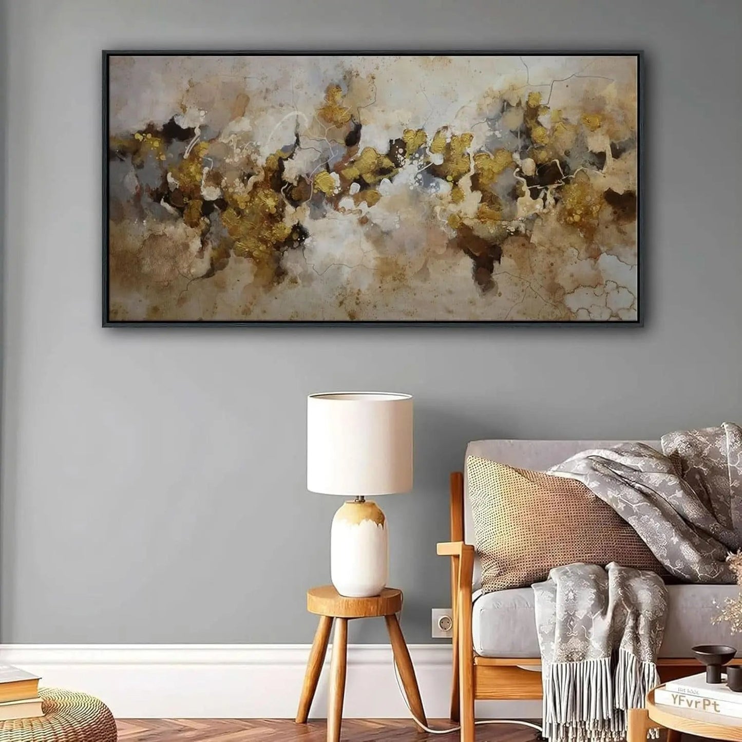 Living room with abstract painting, lamp, and armchair on a gray wall.