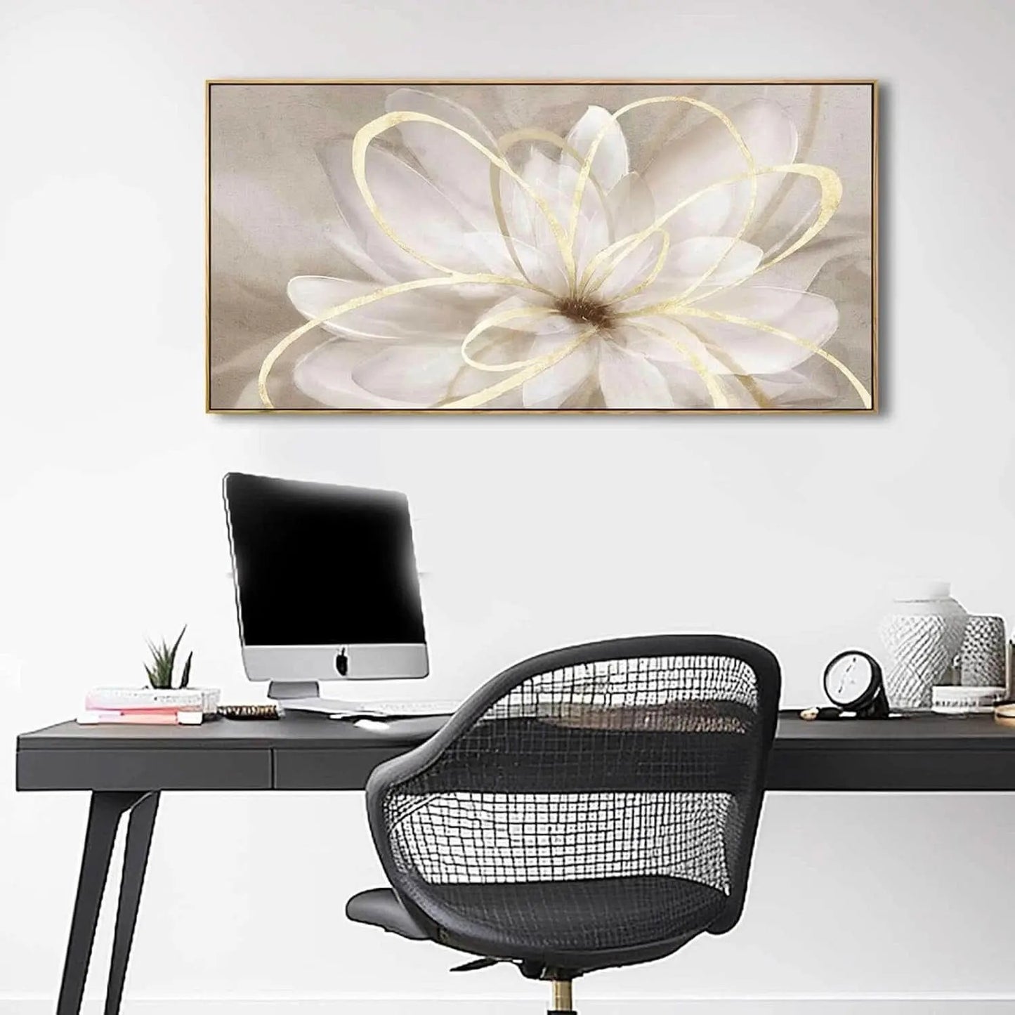 Modern office setup with a desk, chair, and decorative wall art.