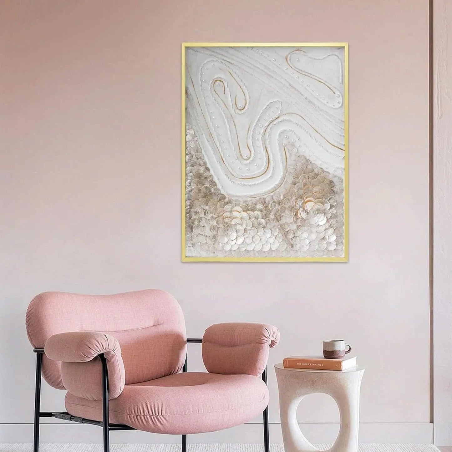 Pink armchair in a room with abstract wall art and a small table.