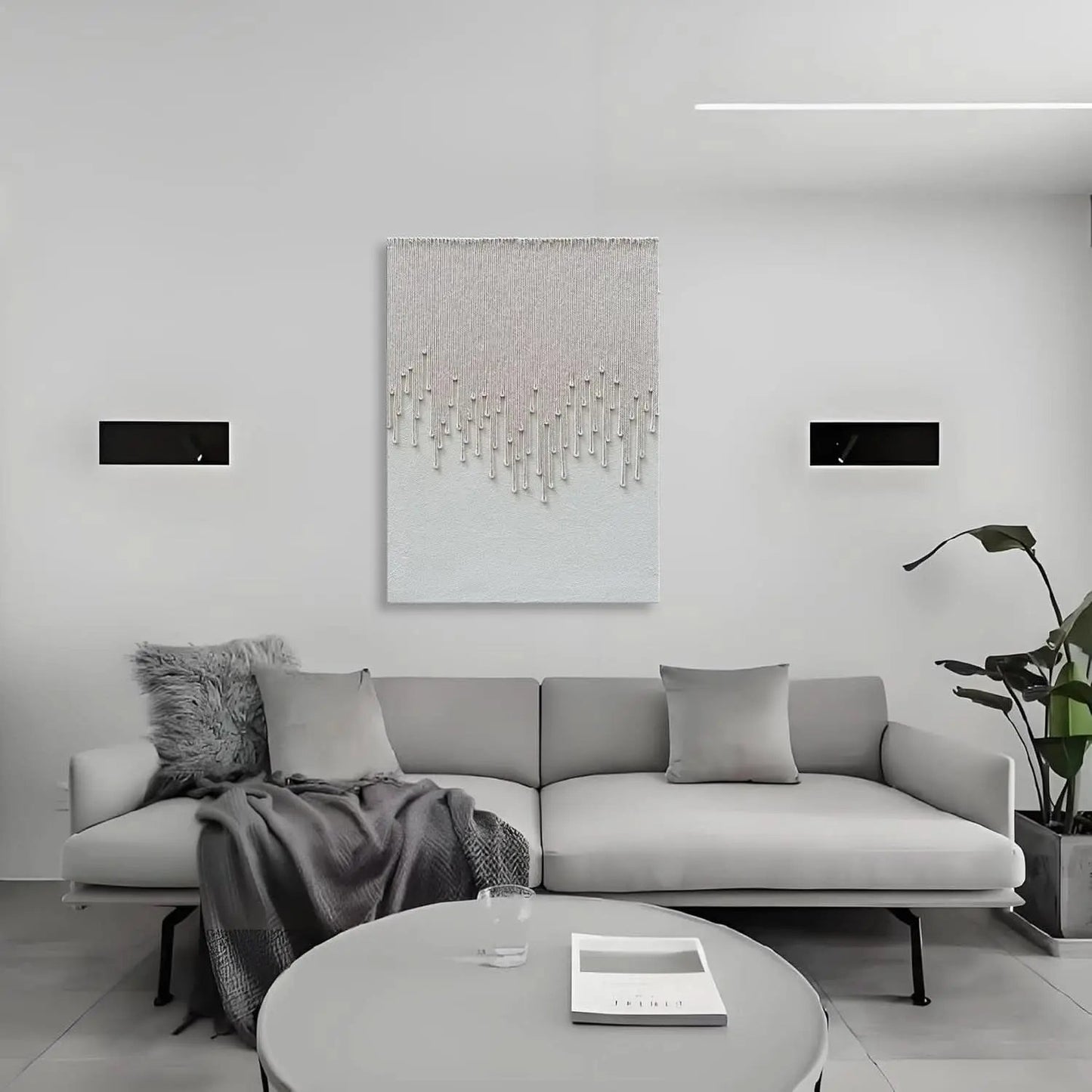 Modern living room with a gray sofa, round coffee table, and abstract art on the wall.