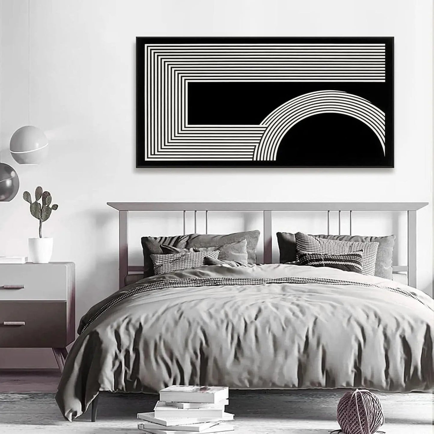 Bedroom with abstract black and white wall art above the bed