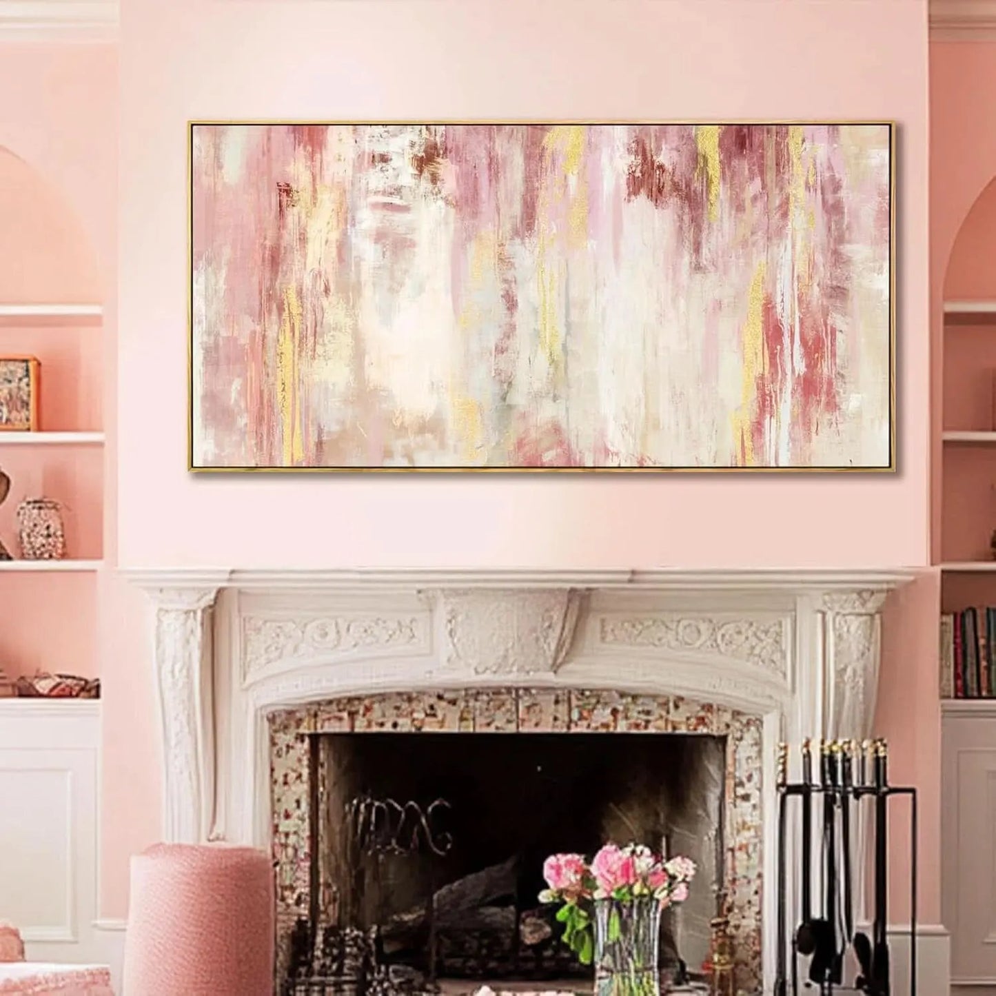 Abstract painting above a fireplace in a room with pink walls and decor.