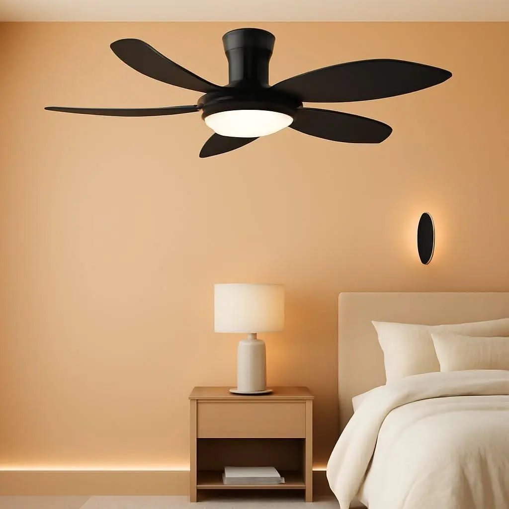 Black ceiling fan in a bedroom with a lamp and bed.