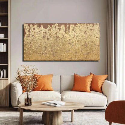 Living room with a beige sofa, wooden coffee table, and gold abstract painting on the wall.