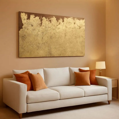White sofa with orange cushions in a living room setting with a large abstract painting on the wall.
