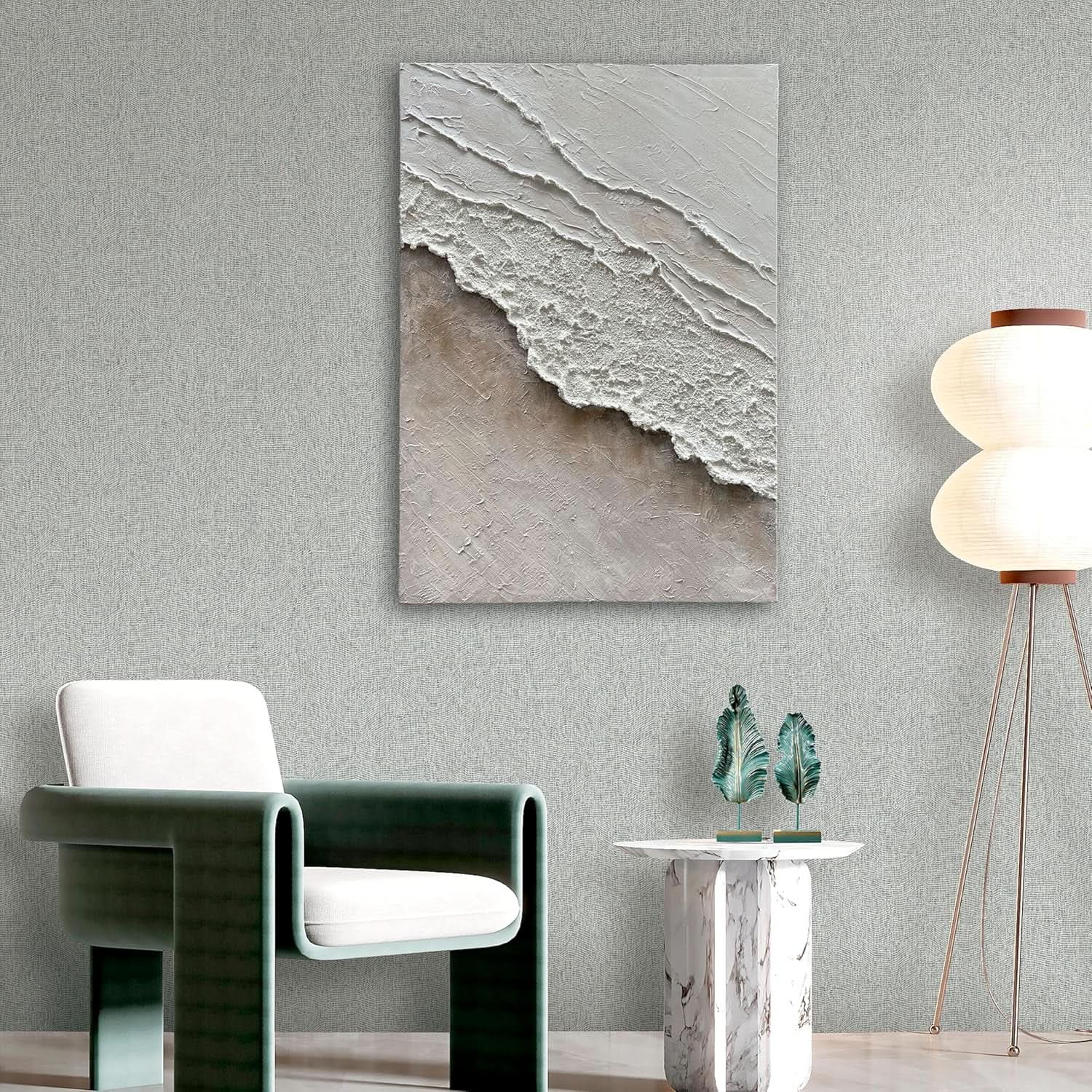 Abstract wall art piece on a gray wall above a modern chair and side table.