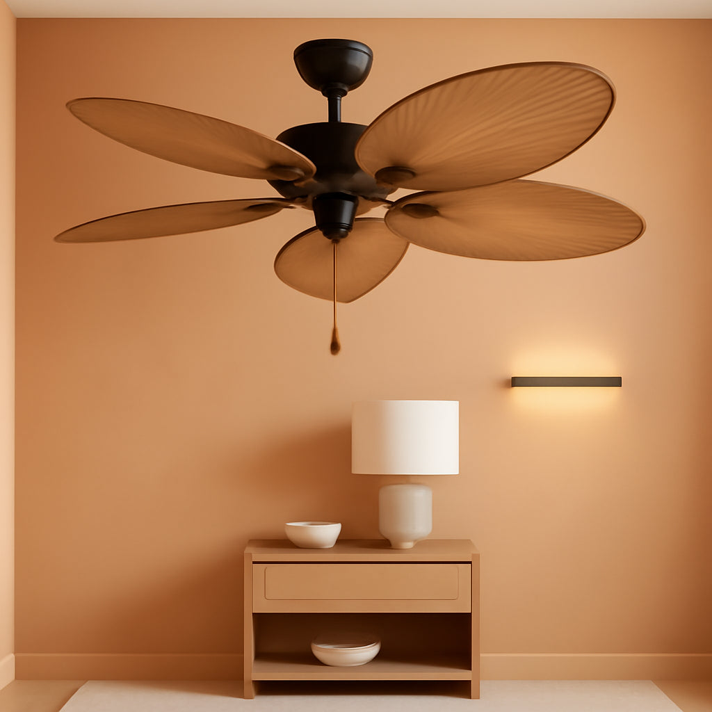 Ceiling fan above a wooden side table with a lamp against an orange wall