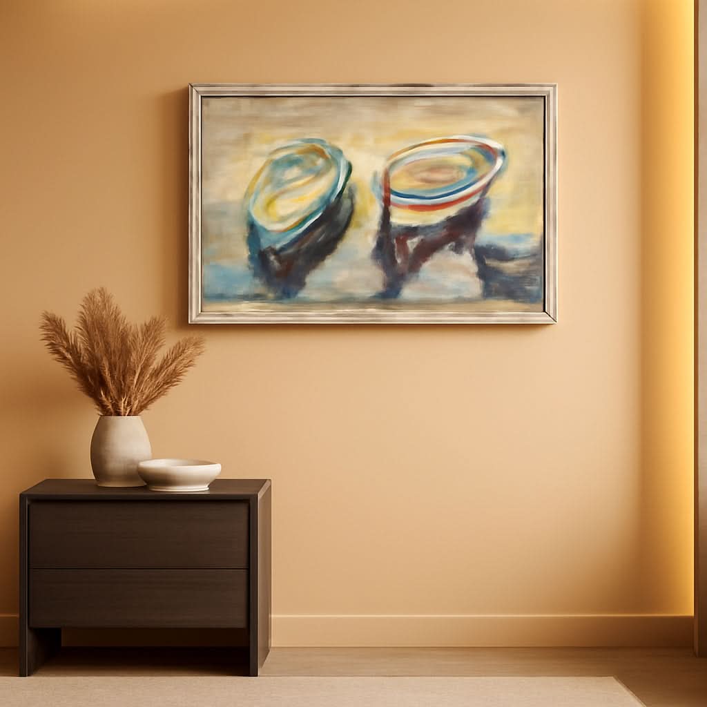 Framed abstract painting on a beige wall above a wooden side table with decorative items.