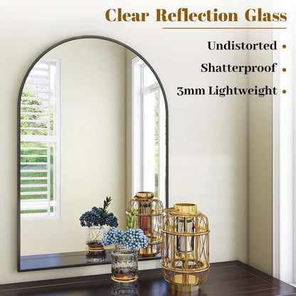 Arched mirror with decorative items on a shelf against a white wall