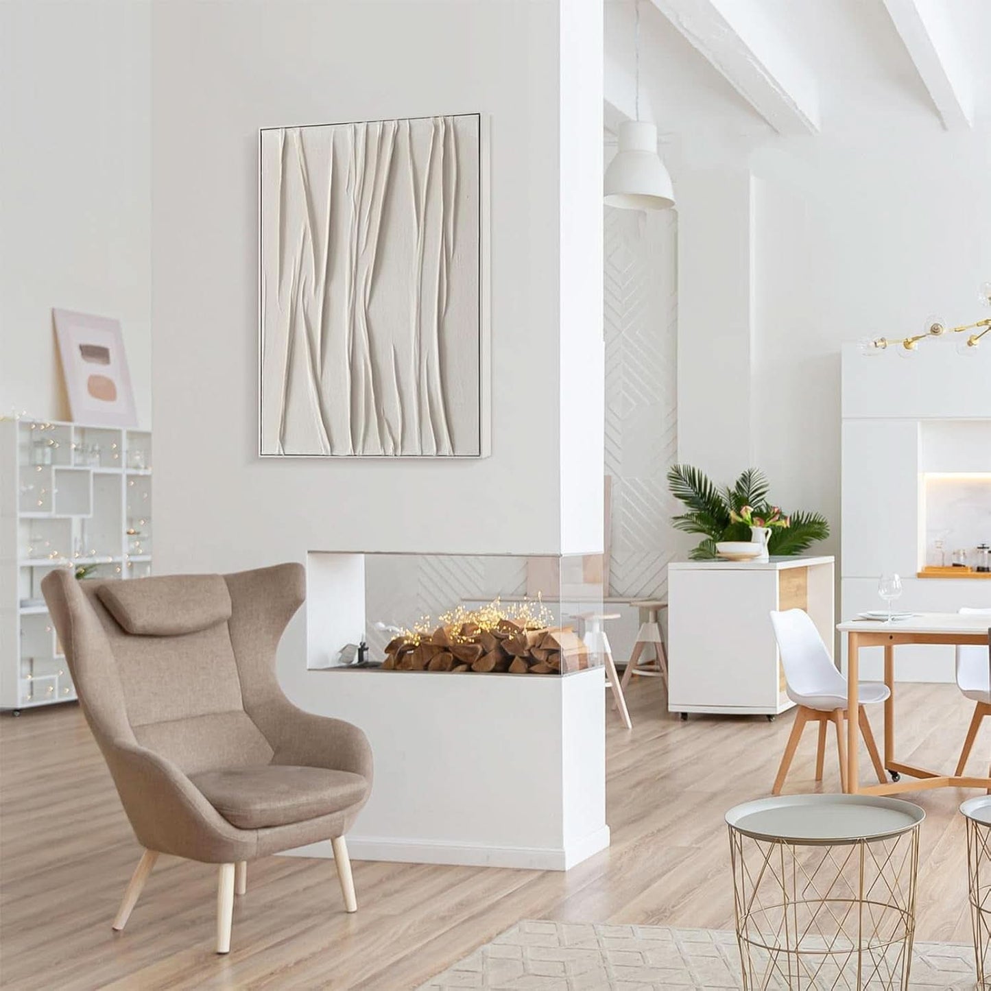 Modern living room with a beige armchair, abstract wall art, and a fireplace.
