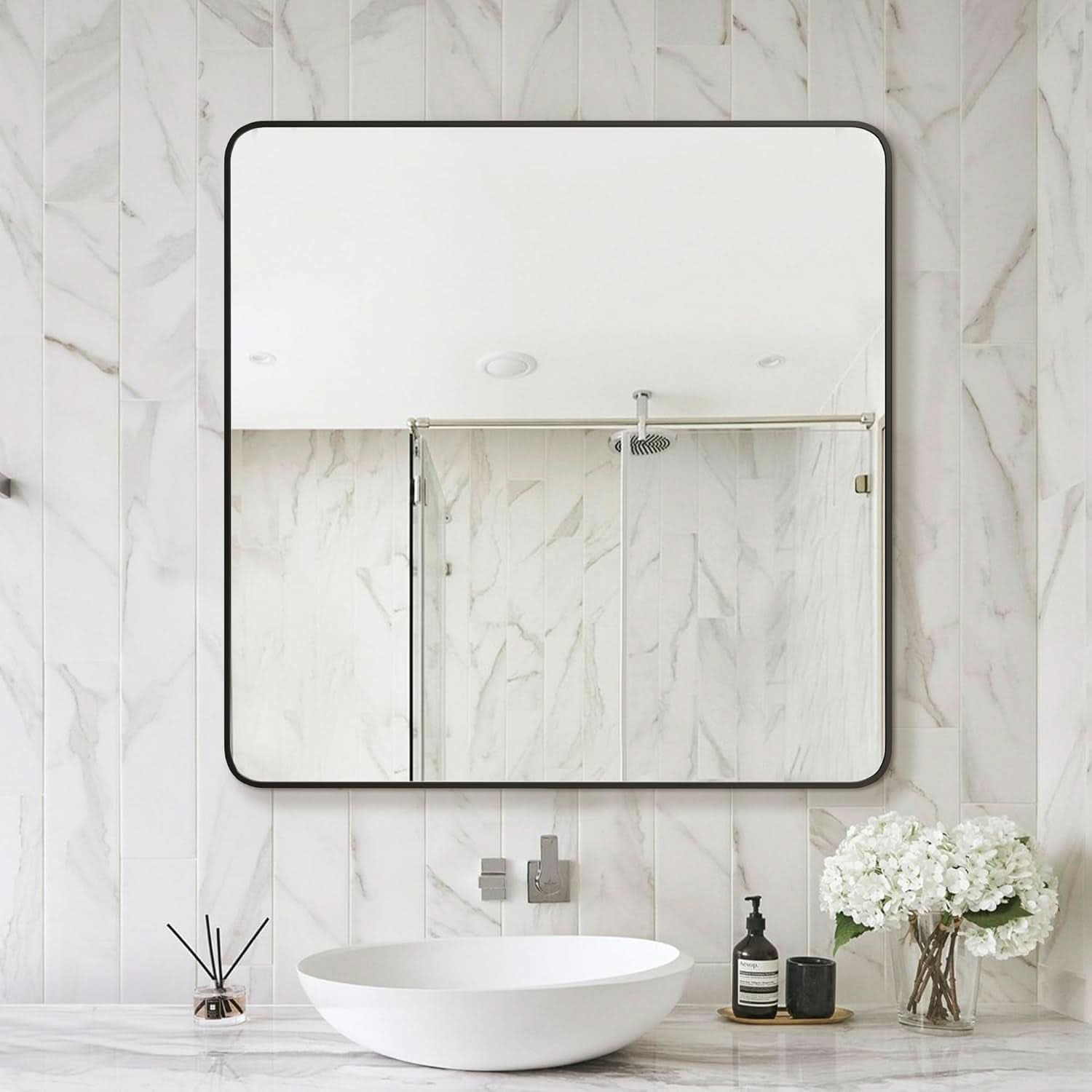 Bathroom with marble wall, sink, and decorative elements