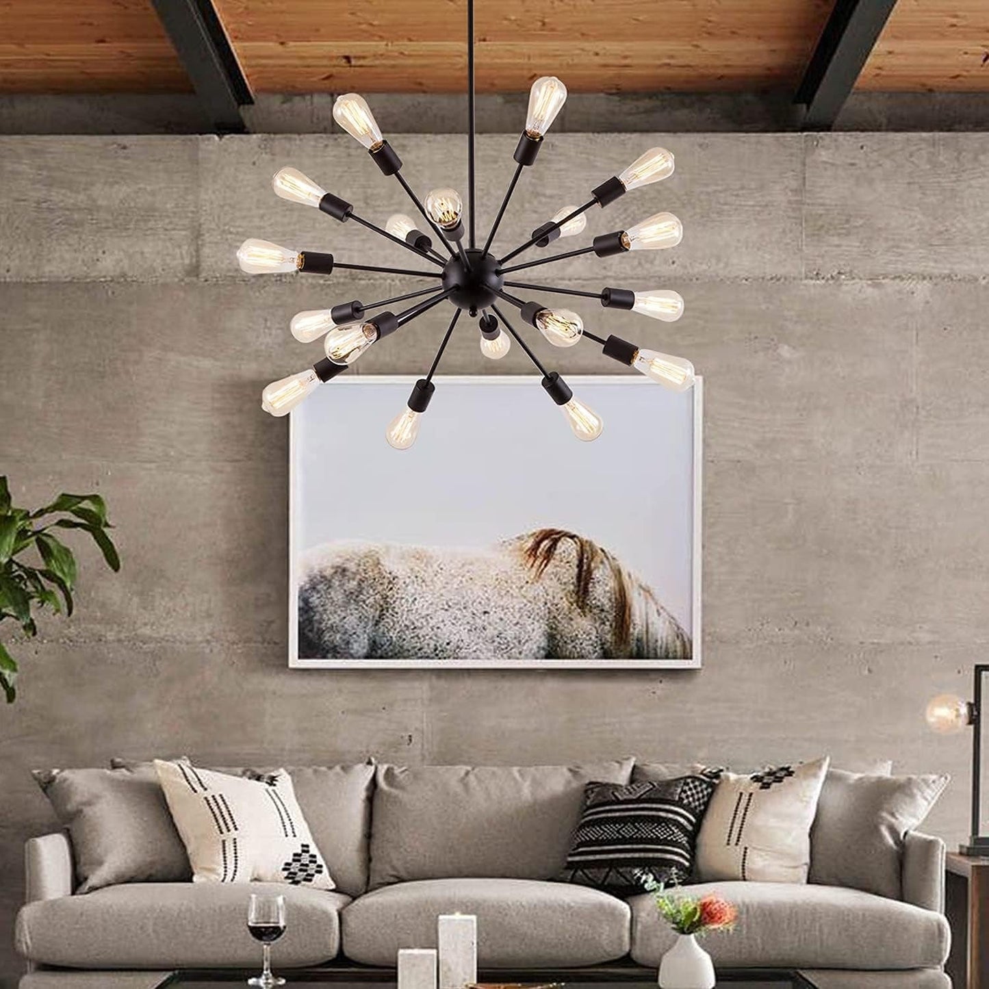 Modern living room with a chandelier, sofa, and wall art.