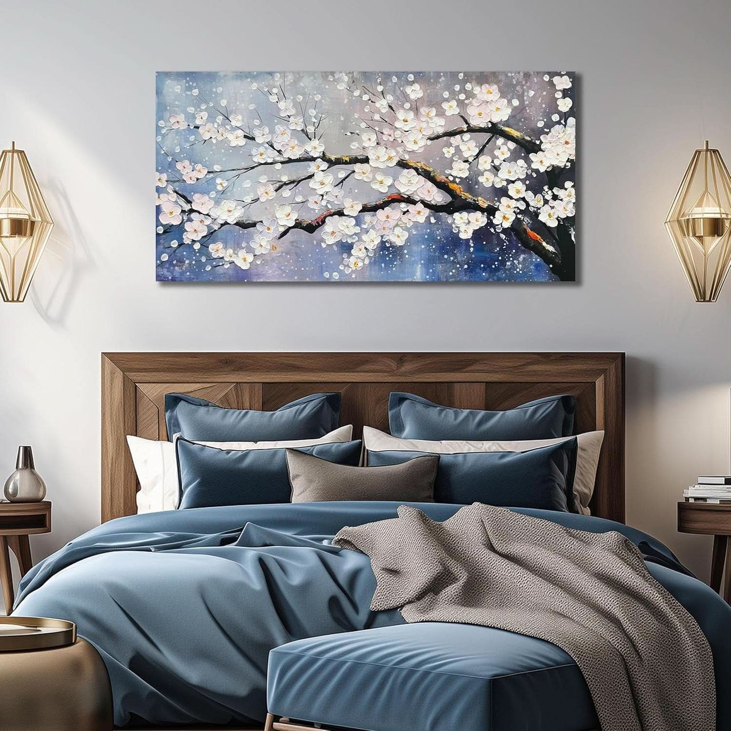 Bedroom with wooden headboard, blue bedding, and cherry blossom painting on wall.