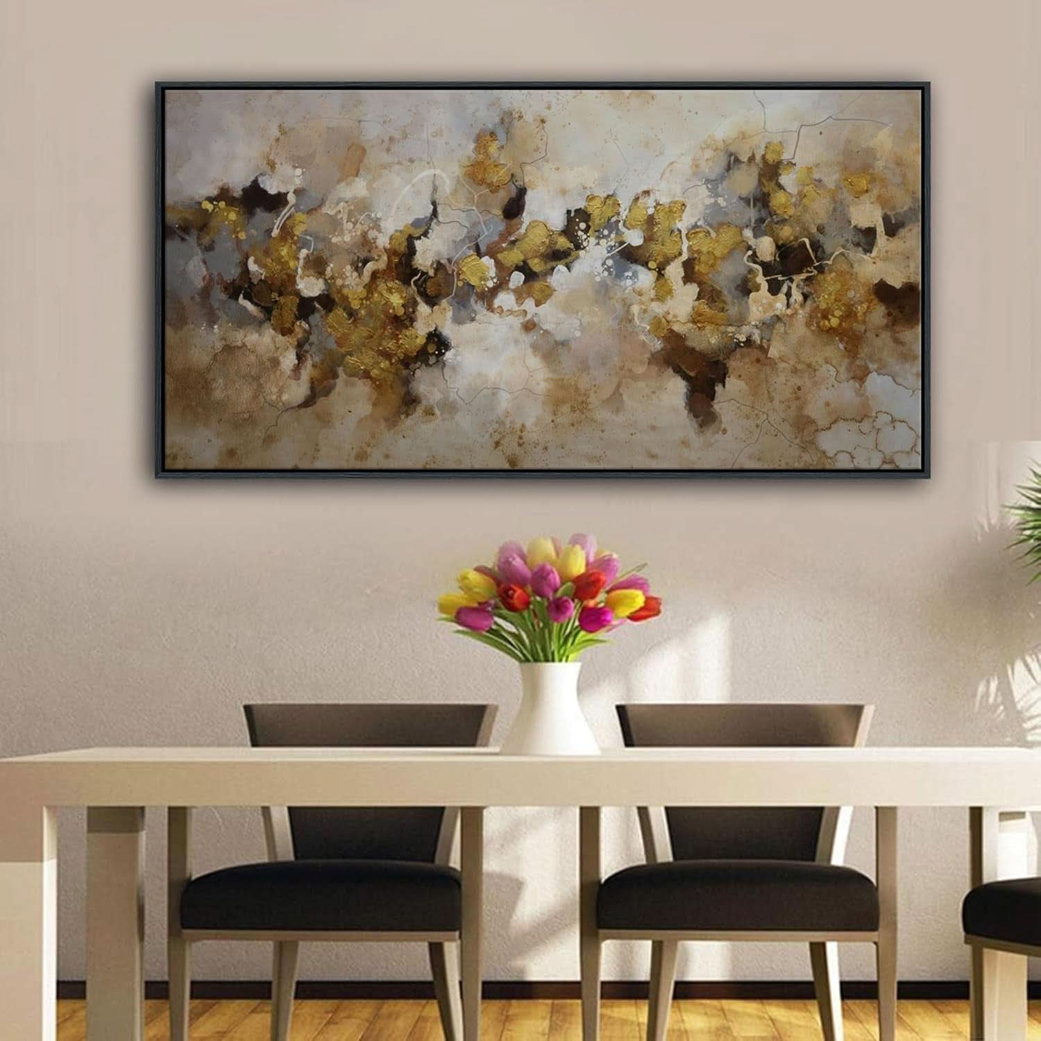 Dining room with a large abstract painting on the wall, a table with chairs, and a vase of flowers.