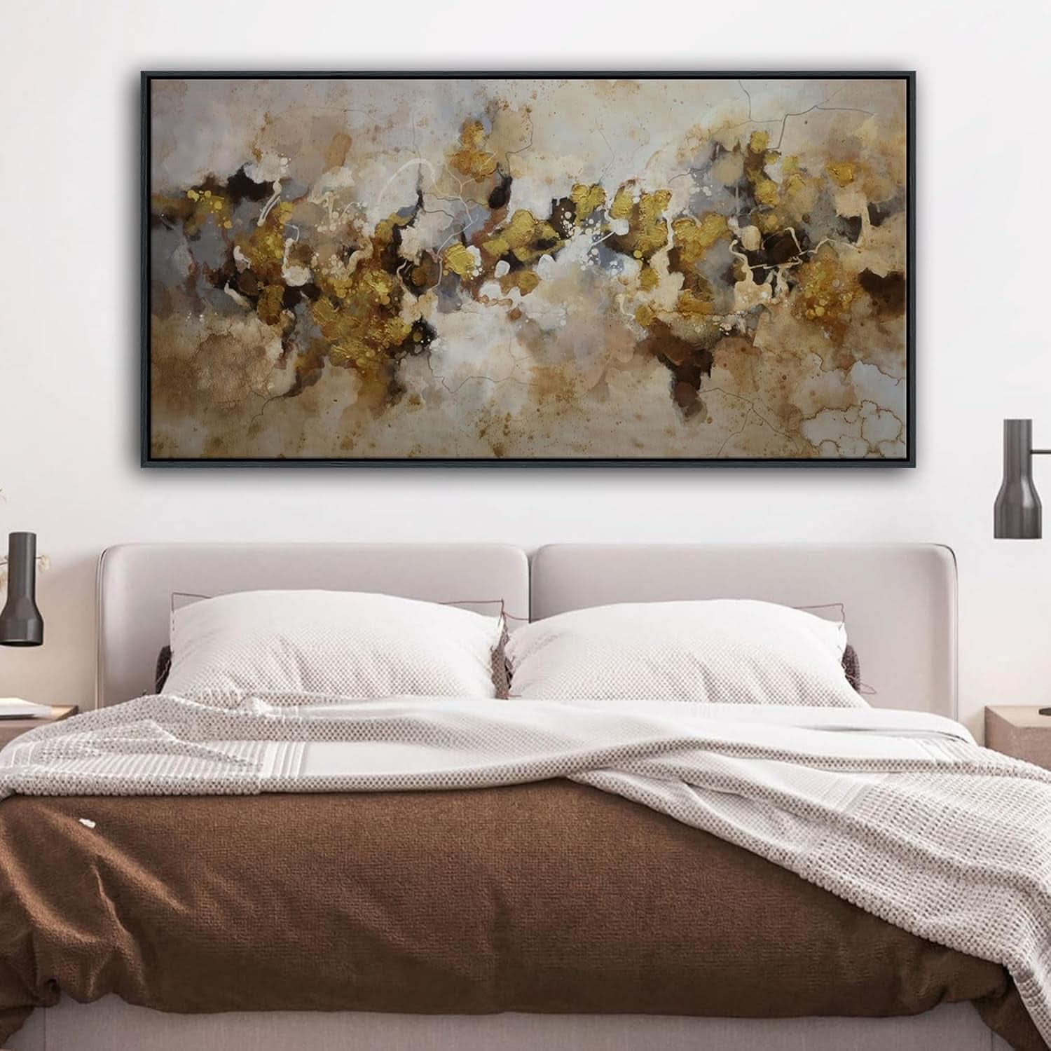 Abstract painting above a bed in a bedroom setting