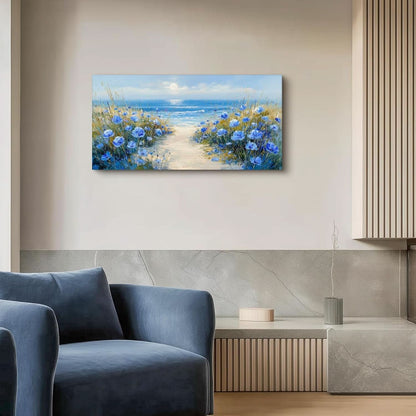 Painting of a beach scene with blue flowers on a wall above a blue armchair.