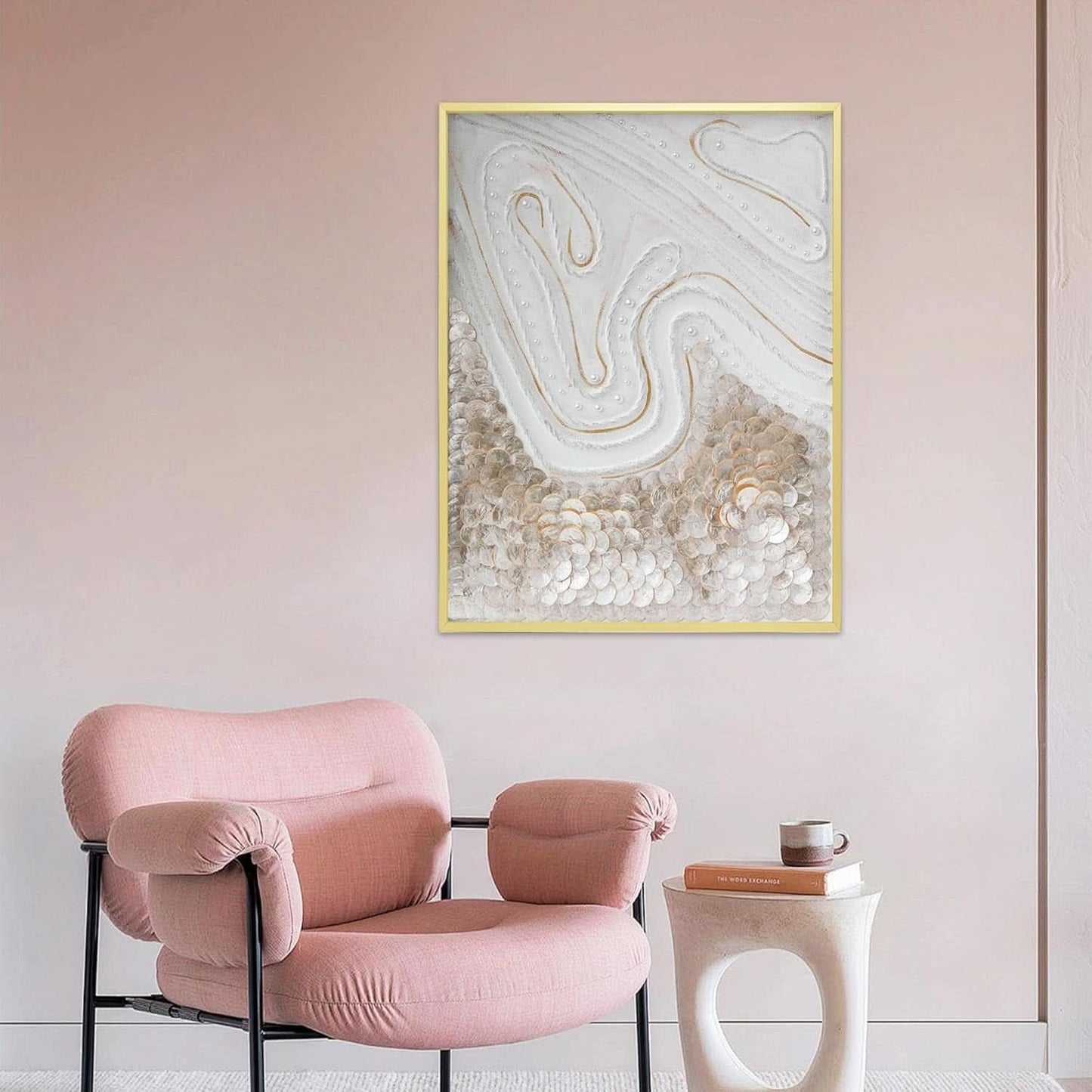 Pink armchair in a room with abstract wall art and a small table.