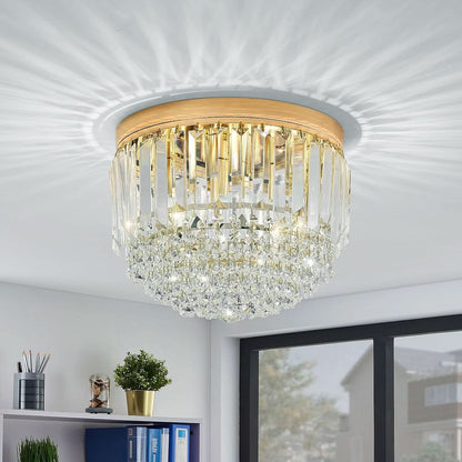 Chandelier with gold frame and clear crystals on a white ceiling
