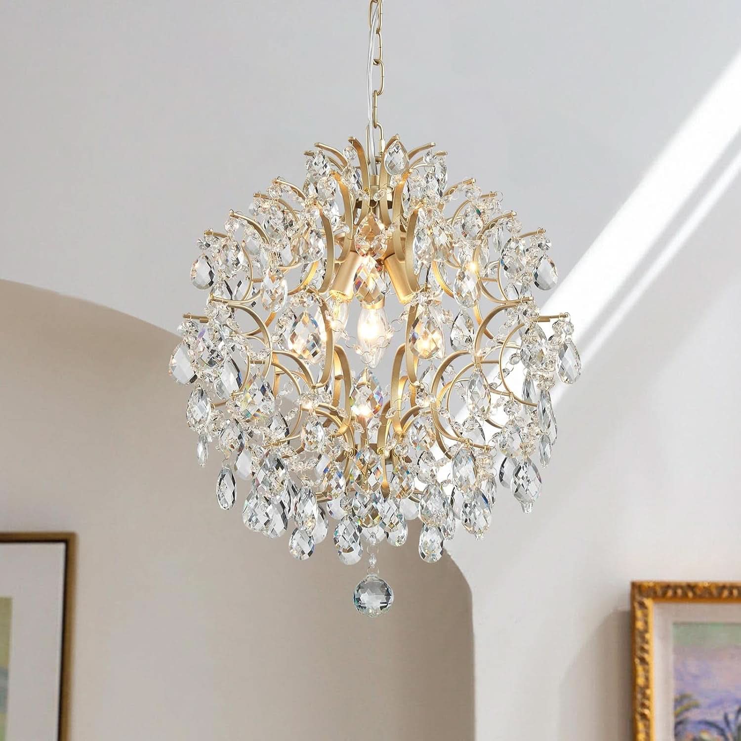 Gold chandelier with crystal accents hanging in a room.