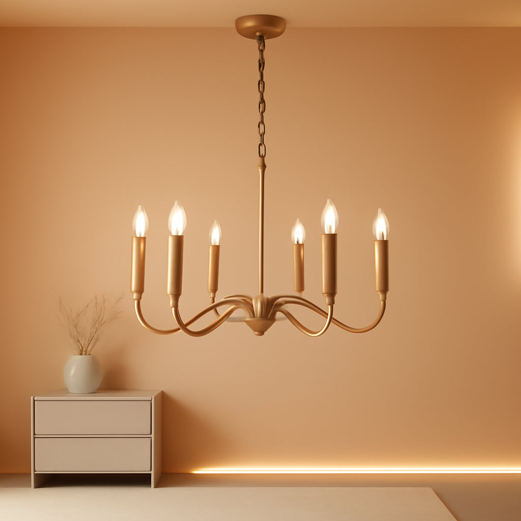 Gold chandelier hanging against a beige wall with a side table and plant.