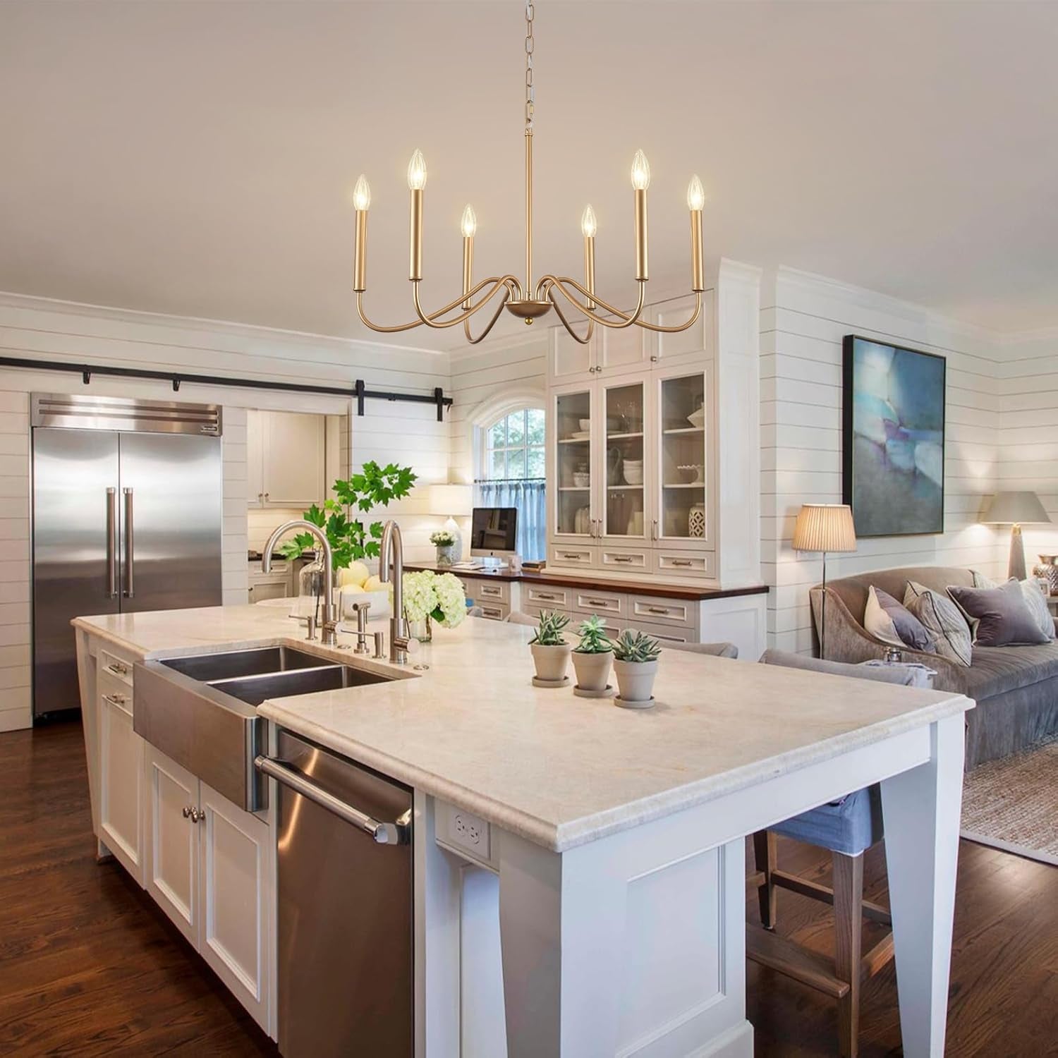 Modern kitchen with island, stainless steel appliances, and living room in the background.