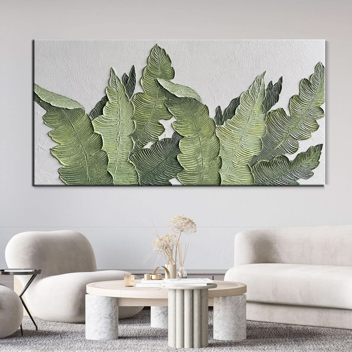 Living room with a large wall art piece featuring green leaves.
