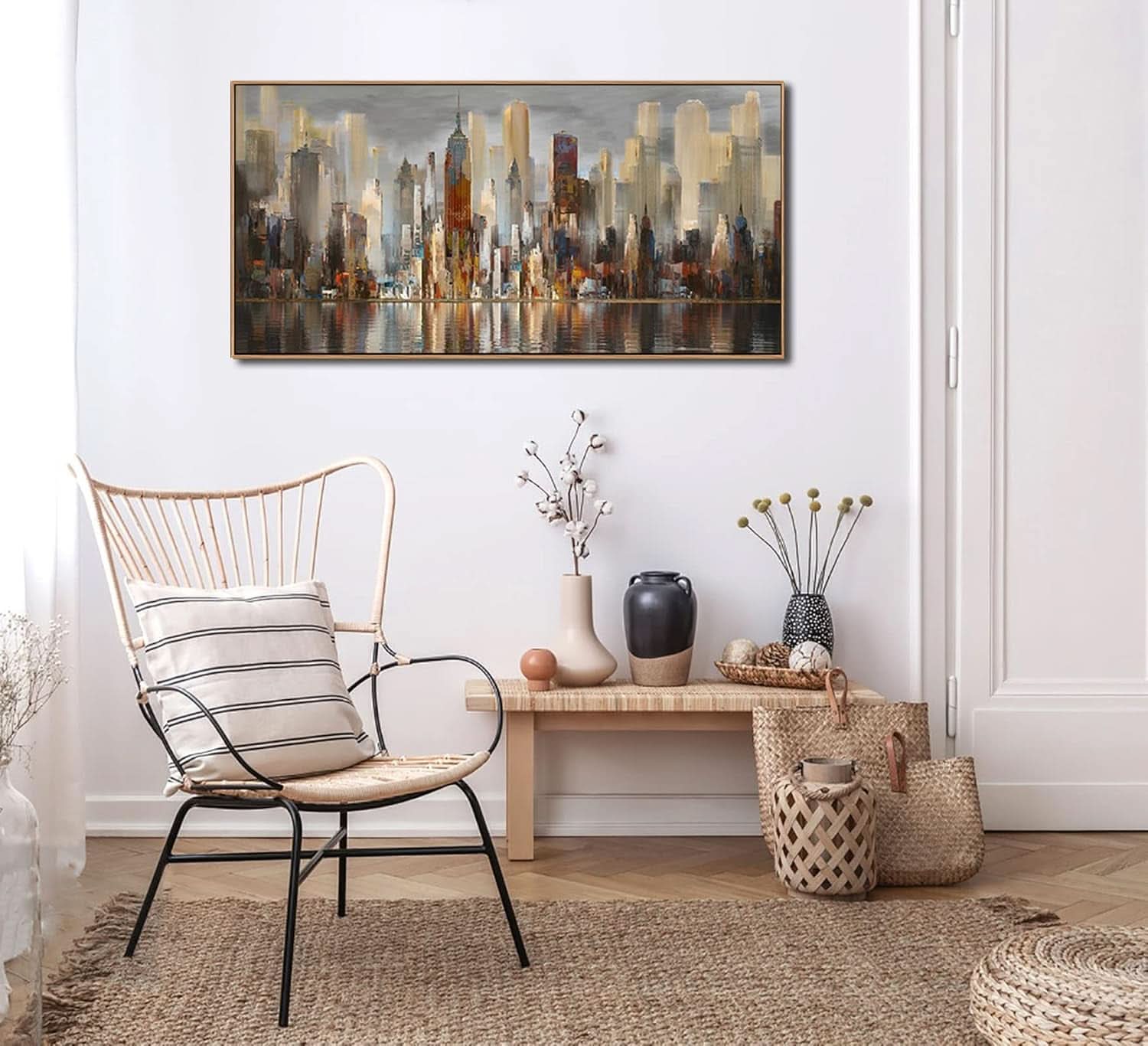 Modern interior with a chair, bench, and decorative items against a white wall with a cityscape painting.