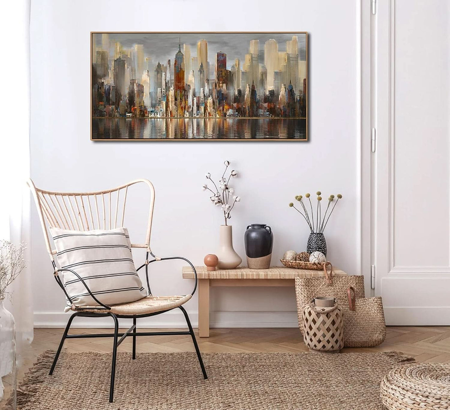 Modern interior with a chair, bench, and decorative items against a white wall with a cityscape painting.