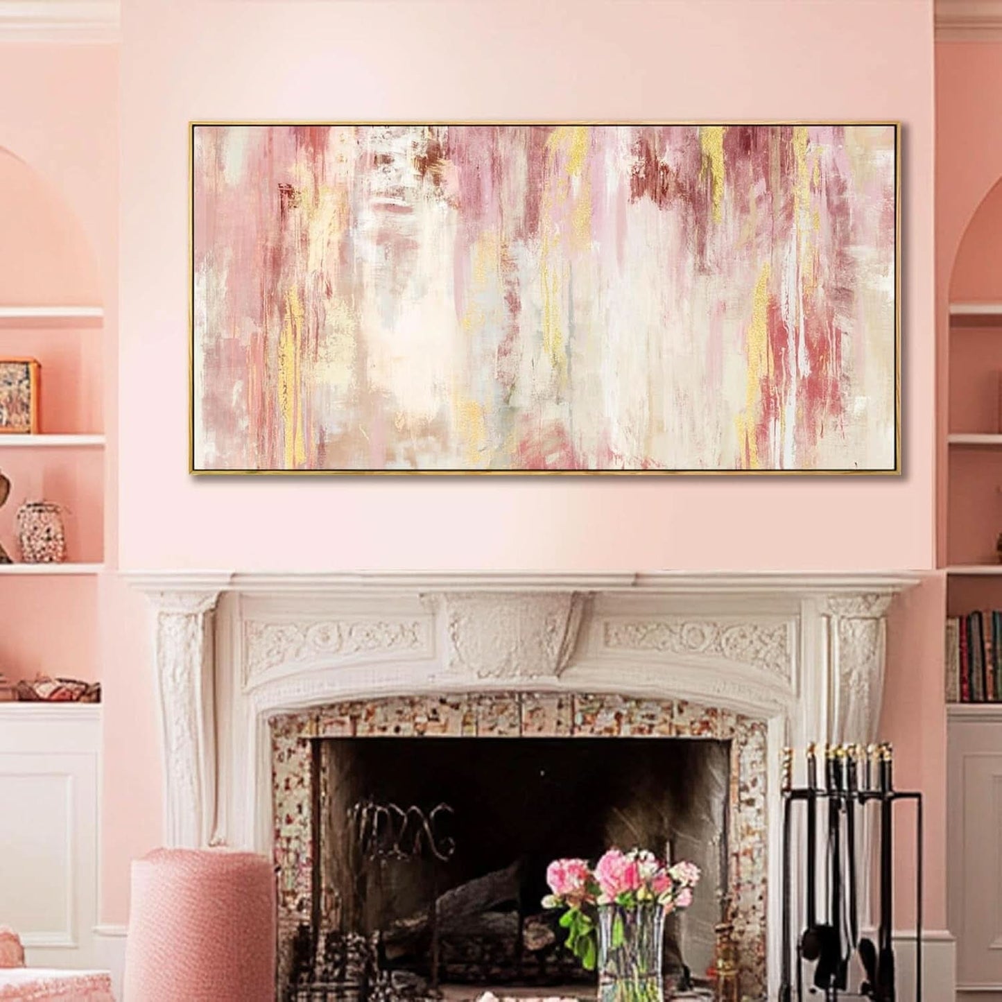 Abstract painting above a fireplace in a room with pink walls and decor.
