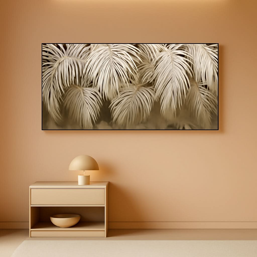 Framed artwork of palm leaves on a beige wall above a wooden side table.