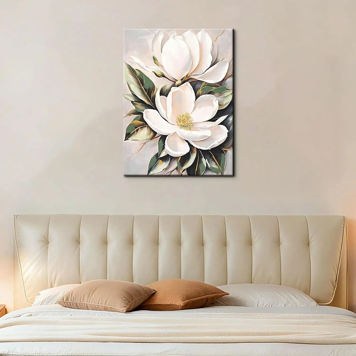 Floral painting above a bed with beige headboard and pillows