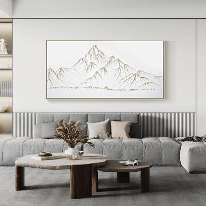 Modern living room with a gray sofa, wooden coffee table, and a framed mountain art piece on the wall.