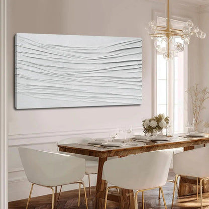 Dining room with a wooden table and white chairs, featuring a large abstract painting on the wall.