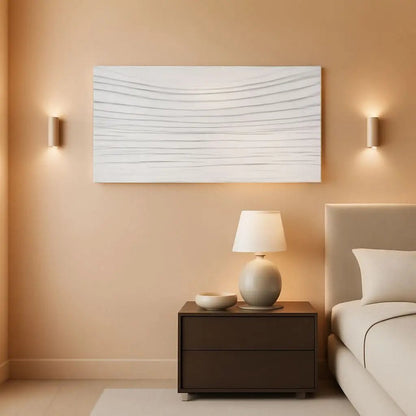 Modern bedroom with a nightstand, lamp, and abstract wall art.