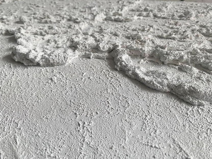 Close-up of textured white surface with cracks and patterns